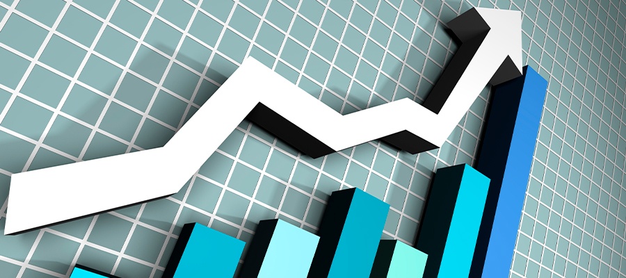Gráfico de crescimento com linha ascendente representando aumento de desempenho ou lucros, em fundo de gráfico com barras azuis e linhas brancas.